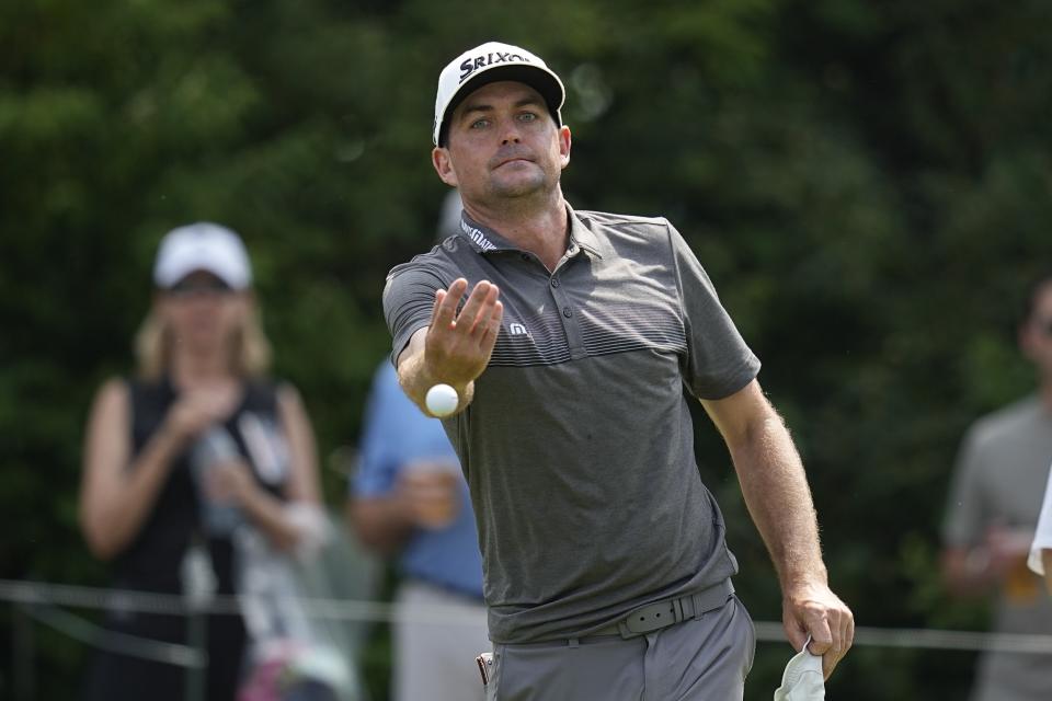 Keegan Bradley tosses a golf ball to a fan on the 15th tee during the third round of the Memorial golf tournament, Saturday, June 3, 2023, in Dublin, Ohio. (AP Photo/Darron Cummings)