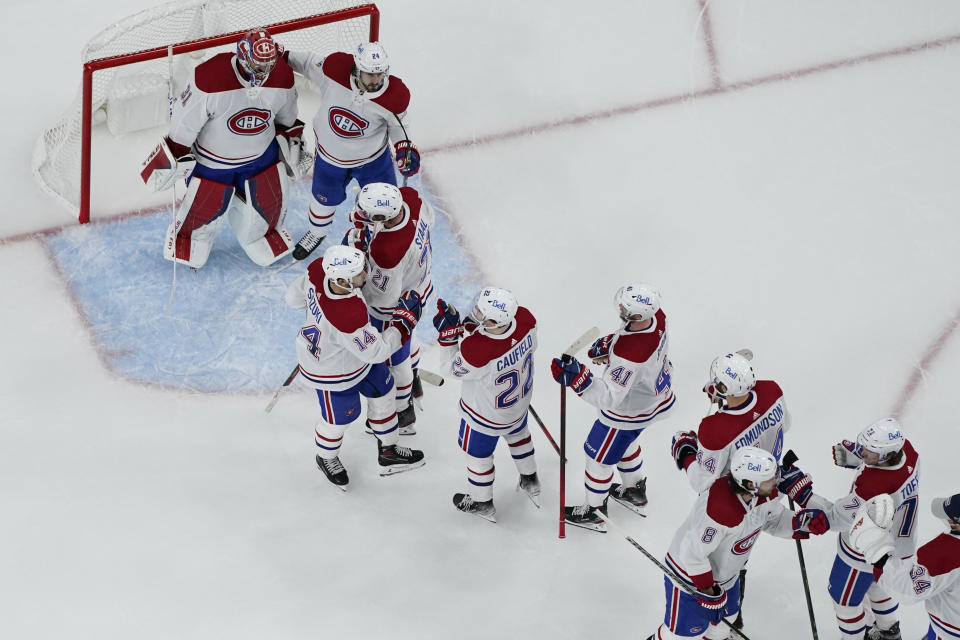 Montreal Canadiens celebrate after defeating the Vegas Golden Knights in Game 5 of an NHL hockey Stanley Cup semifinal playoff series Tuesday, June 22, 2021, in Las Vegas. (AP Photo/John Locher)