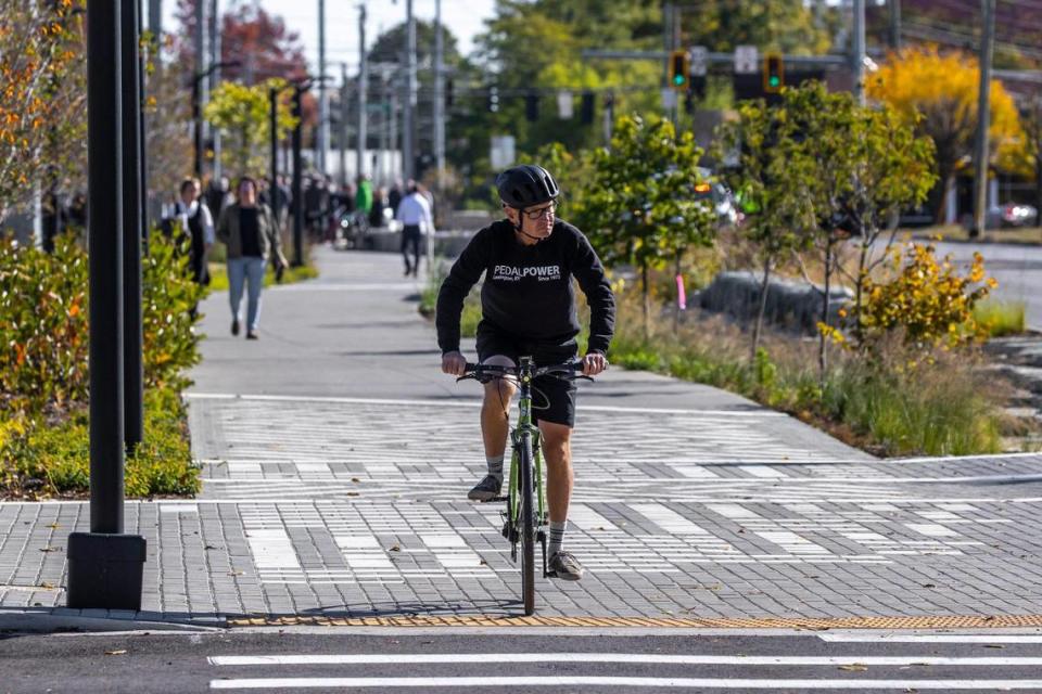 Howard Florence cycles along the Town Branch Commons path near Midland Avenue in Lexington, Kentucky, following a ribbon-cutting ceremony on Thursday, October 13, 2022, completing the two-mile path through downtown.