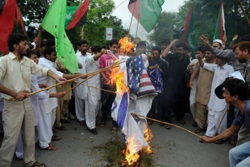 Pakistani Muslims protesters torch US and Israeli flags as they attempt to reach the US embassy during a demonstration in Islamabad. Anti-US protests by crowds whipped into fury by a film that ridicules Islam's Prophet Mohammed erupted across the Arab world on Friday, leading to an explosion of violence in Sudan, Yemen and Lebanon