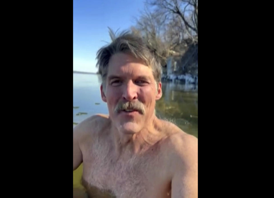 This screen shot from cell phone video provided by Eric Hovde’s campaign shows the candidate for U.S. Senate shirtless in the cold waters of Lake Mendota in Madison, Wis. on Thursday, Feb. 29, 2024. He was hoping to show he’s more of a hardy Wisconsinite than a soft Californian. He also challenged his Democratic challenger, U.S. Sen. Tammy Baldwin, to take a cold plunge as well. (Eric Hovde via AP)