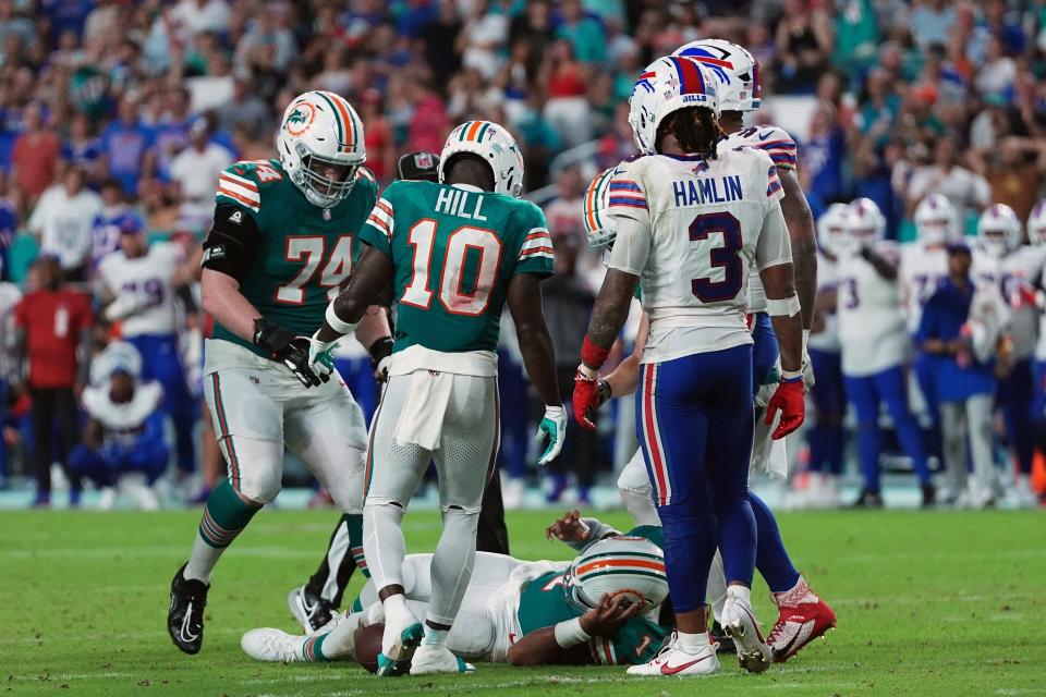 Sep 12, 2024; Miami Gardens, Florida, USA; Miami Dolphins quarterback Tua Tagovailoa (1) sufferes an apparent concussion after hitting his head on the ground while being tackled by Buffalo Bills safety Damar Hamlin (3) during the second half at Hard Rock Stadium. Mandatory Credit: Jasen Vinlove-Imagn Images