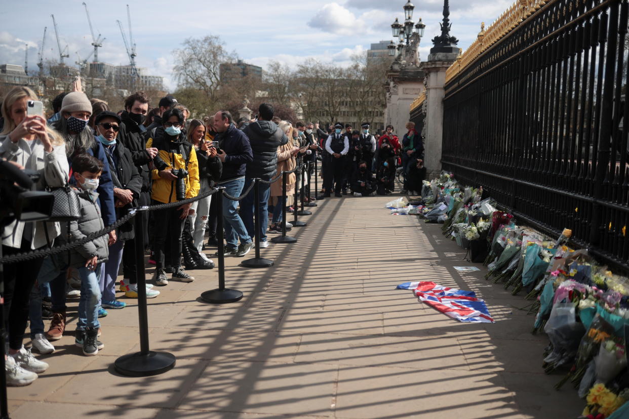 Mourners gather outside Buckingham Palace after Britain's Prince Philip, husband of Queen Elizabeth, died at the age of 99, in London, Britain, April 9, 2021. REUTERS/Hannah McKay