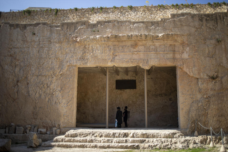 In this Thursday, Oct. 31, 2019 photo, ultra-Orthodox Jews pray in the Tomb of the Kings, a large underground burial complex dating to the first century BC, in east Jerusalem neighborhood of Sheikh Jarrah. After several aborted attempts, the French Consulate General has reopened one of Jerusalem's most magnificent ancient tombs to the public for the first time in over a decade, sparking a distinctly Jerusalem conflict over access to an archaeological-cum-holy site in the volatile city's eastern half. (AP Photo/Ariel Schalit)