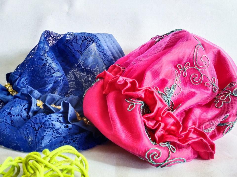 Blue and pink satin bonnets laid out with white background