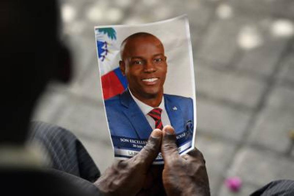 A mourner holds a photo of late Haitian President Jovenel Moïse during a memorial ceremony at the National Pantheon Museum in Port-au-Prince in July 2021.