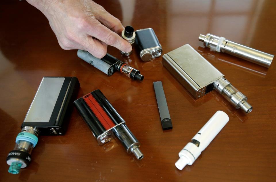 Marshfield High School Principal Robert Keuther displays vaping devices that were confiscated from students in such places as restrooms or hallways at the school in Marshfield, Mass., on April 10, 2018.
