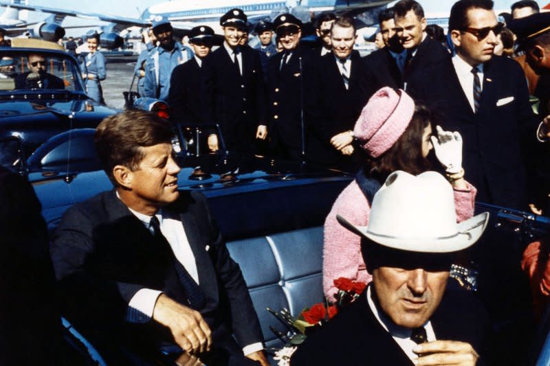 Texas Gov. John Connally adjusts his tie as President John F. Kennedy and first lady Jacqueline Kennedy, settled in rear seats, prepare for a motorcade into Dallas on November 22, 1963. The president Kennedy was assassinated a few hours later. UPI File Photo