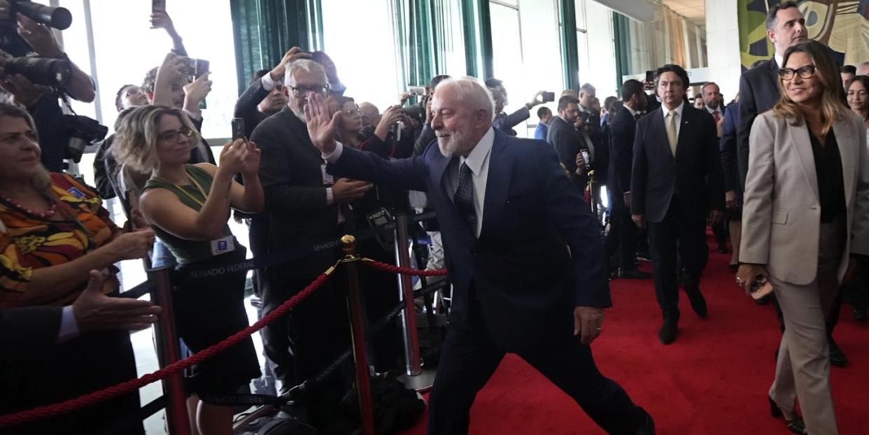 Brazilian President Lula greets journalists, in Brasilia, one year after rioters stormed the presidential palace, Congress and Supreme Court buildings. <a href="https://newsroom.ap.org/detail/APTOPIXBrazilRiotsOneYear/ba4ead6af3f84bd587b23503bf8dd425/photo?Query=lula&mediaType=photo&sortBy=arrivaldatetime:desc&dateRange=Anytime&totalCount=7372&currentItemNo=41" rel="nofollow noopener" target="_blank" data-ylk="slk:AP Photo/Eraldo Peres;elm:context_link;itc:0;sec:content-canvas" class="link ">AP Photo/Eraldo Peres</a>