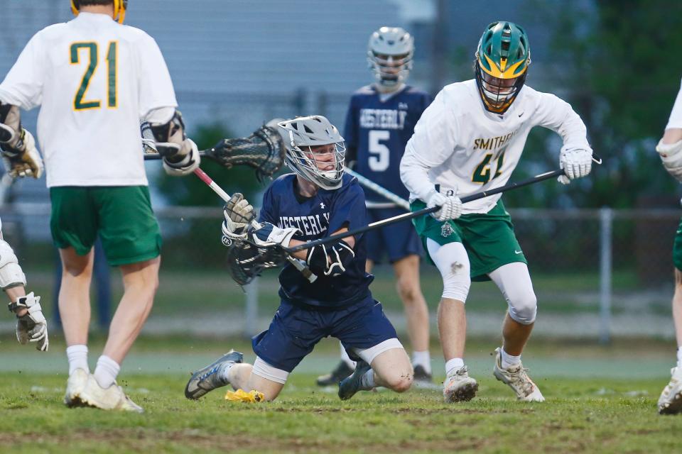 Westerly's Lance Williams makes a play from his knees during a game against Smithfield earlier this week. On Friday, he scored three goals in the Bulldogs' win over Narragansett.