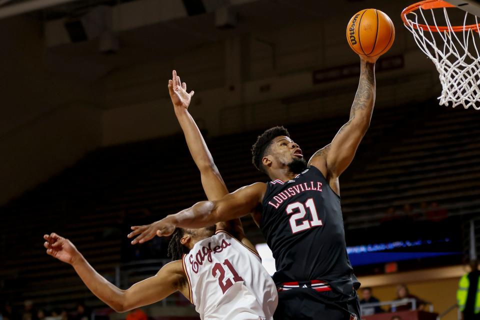 Louisville forward Sydney Curry (21) drives the basket while defended by Boston College forward Devin McGlockton (21) during the first half of an NCAA college basketball game Wednesday, Jan. 25, 2023, in Boston. (AP Photo/Greg M. Cooper)