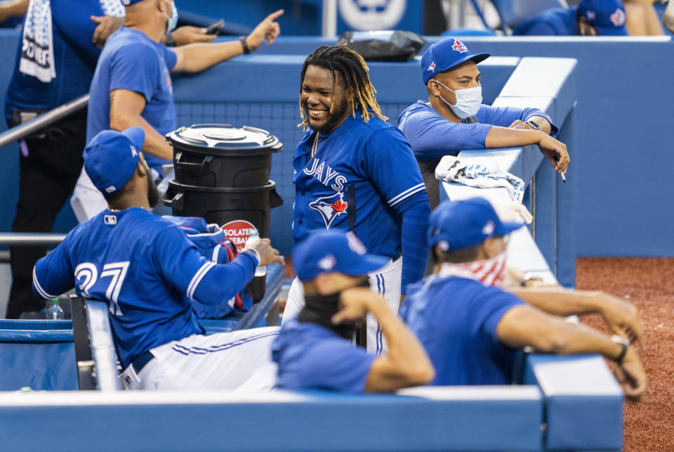 TORONTO, ON - JULY 09:  Vladimir Guerrero Jr. #27 of the Toronto Blue Jays smiles in the dugout during an intrasquad game at Rogers Centre on July 9, 2020 in Toronto, Canada. / Credit: Mark Blinch / Getty Images