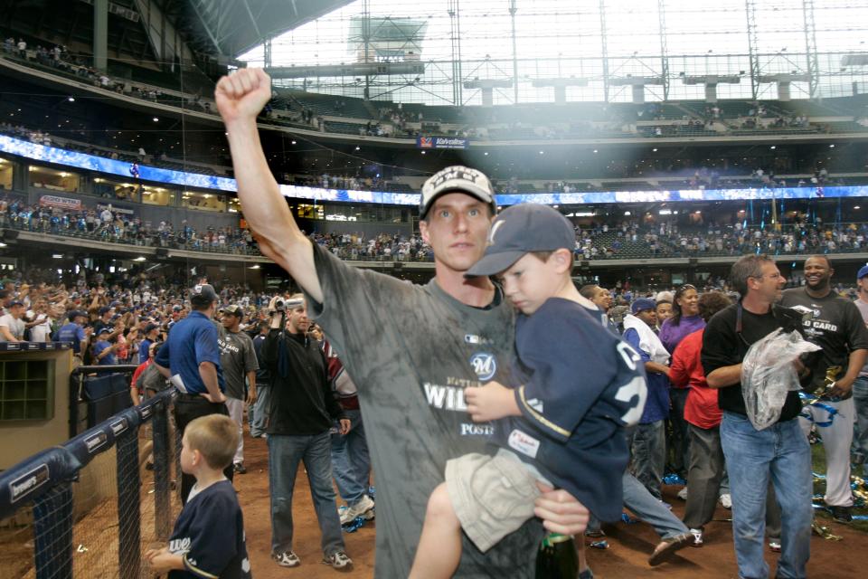 Milwaukee Brewers' Craig Counsell enjoys the celebration with his son after beating the Chicago Cubs at Miller Park on September 28, 2008.