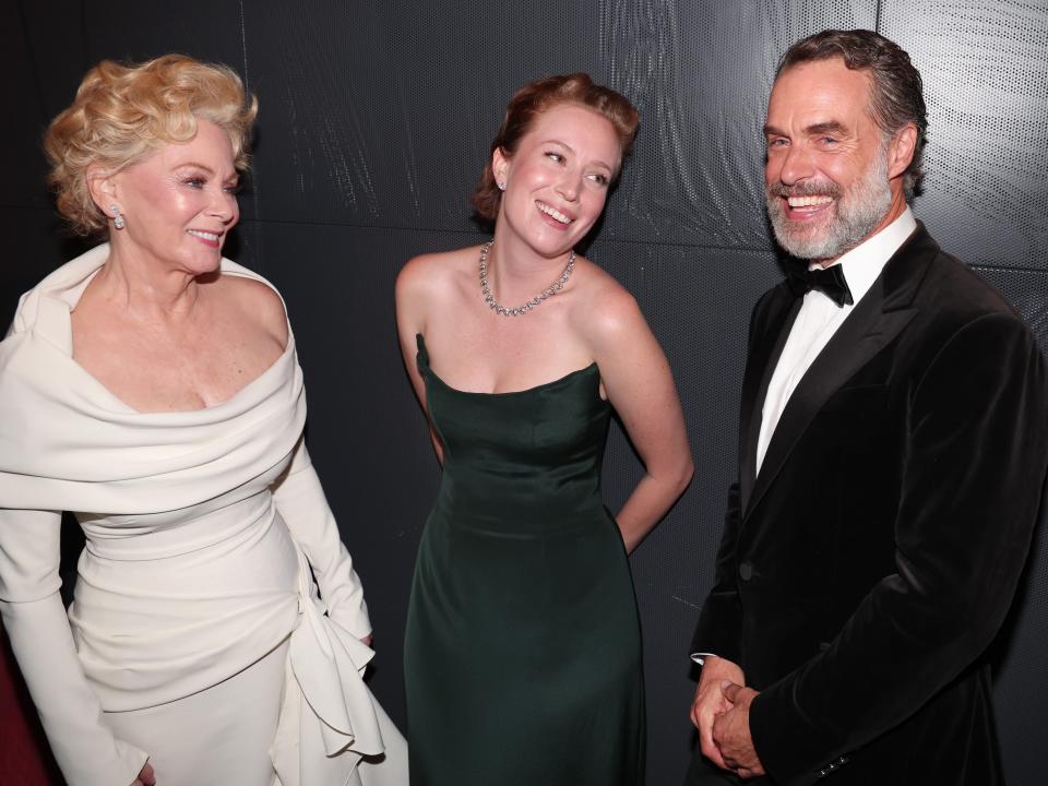 jean smart in a white dress, hannah einbinder in a green dress, and murray bartlett in a black suit at the emmys