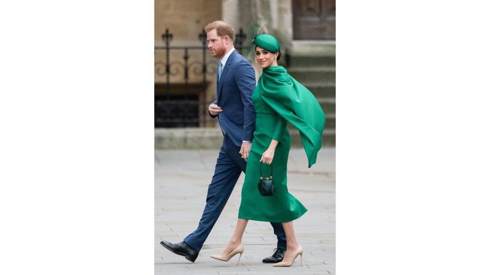 Meghan in green walking with harry