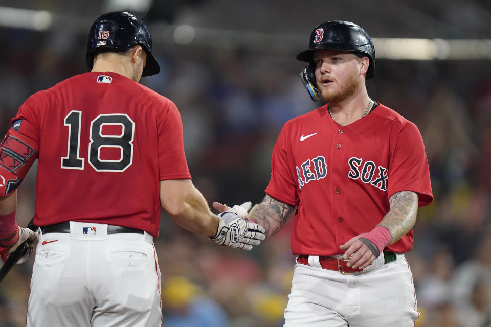 Boston Red Sox's Alex Verdugo, right, celebrates with Adam Duvall (18) after scoring against the Houston Astros during the third inning of a baseball game Tuesday, Aug. 29, 2023, in Boston. (AP Photo/Steven Senne)