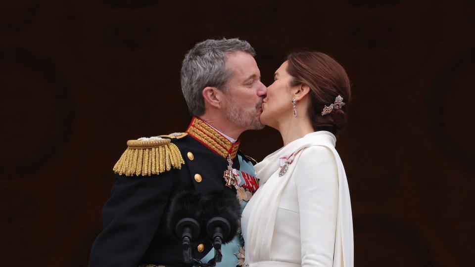 couple kissing on balcony 