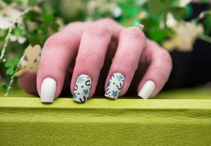 saint patricks day inspired nail art that has clovers and horseshoes