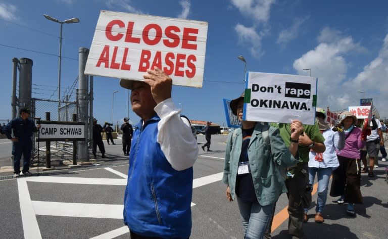 People protest against the presence of US bases on the southern Japanese island of Okinawa in front of the entrance the US Marine Corps' Camp Schwab in Nago, Okinawa, on June 17, 2016