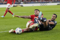 Benfica's Nicolas Otamendi, left, and Real Sociedad's Mikel Merino fight for the ball during the Champions League group D soccer match between SL Benfica and Real Sociedad at the Luz stadium in Lisbon, Tuesday, Oct. 24, 2023. (AP Photo/Armando Franca)