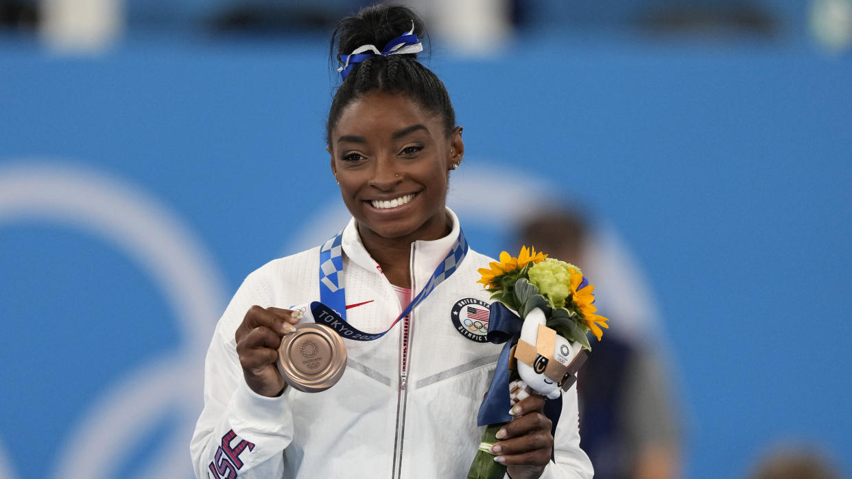 FILE - U.S. gymnast Simone Biles poses with her bronze medal for the artistic gymnastics women's balance beam apparatus at the 2020 Summer Olympics, Tuesday, Aug. 3, 2021, in Tokyo, Japan. USA Gymnastics announced Wednesday, June 28, 2023, that Biles, the 2016 Olympic champion, will be part of the field at the U.S. Classic outside of Chicago on Aug. 5. The meet will be Biles first since the 2020 Olympics. (AP Photo/Jae C. Hong, File)