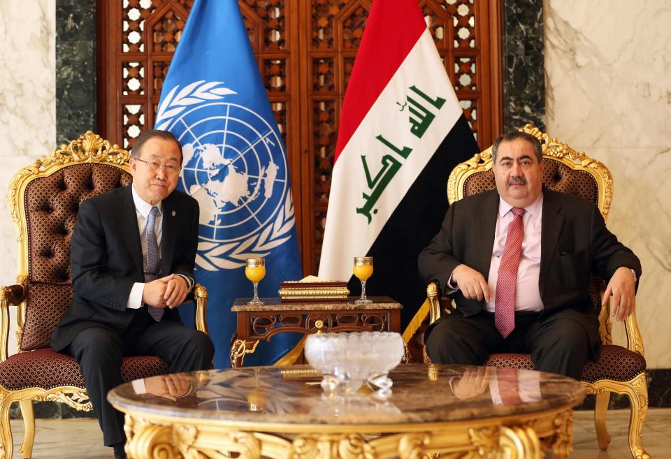Iraqi Foreign Minister Hoshyar Zebari, right, poses for photographers with United Nations Secretary-General Ban Ki-moon, left, at Baghdad airport, Iraq, Monday, Jan. 13, 2014. The U.N. chief has arrived in Baghdad as an unprecedented standoff is underway between Iraqi troops and al-Qaida-linked militants in western Anbar province. (AP Photo/Hadi Mizban, Pool)