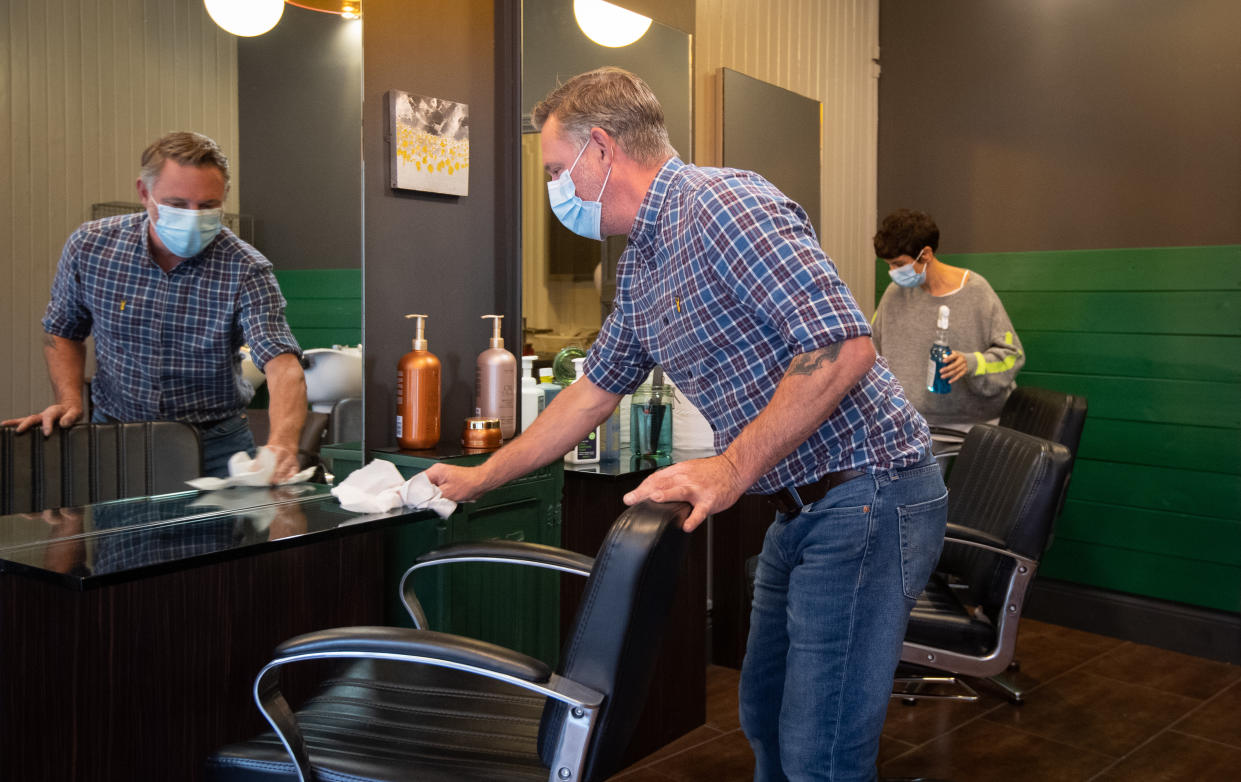 Robin Dignall and Maria Demetriou-Clamp disinfect chairs at their hair salon Hair@1RD in Leicester as the city may be the first UK location to be subjected to a local lockdown after a spike in coronavirus cases.