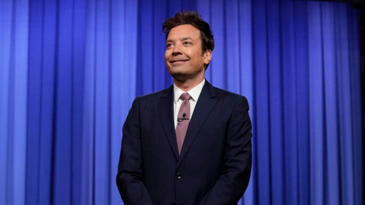  Jimmy Fallon in front of blue curtain on The Tonight Show 