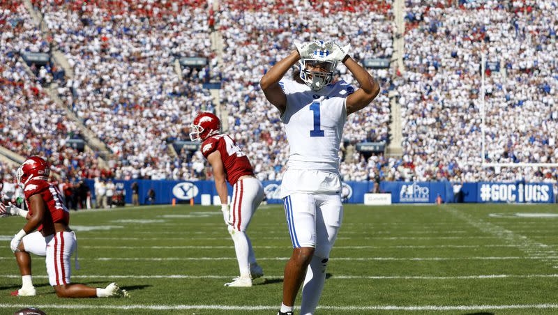 BYU receiver Keanu Hill makes a heart for fans after scoring a touchdown against the Arkansas Razorbacks in Provo on Saturday, Oct. 15, 2022. Hill is one of the anchors in the receivers room, which could be elite when BYU begins life in the Big 12 this fall.