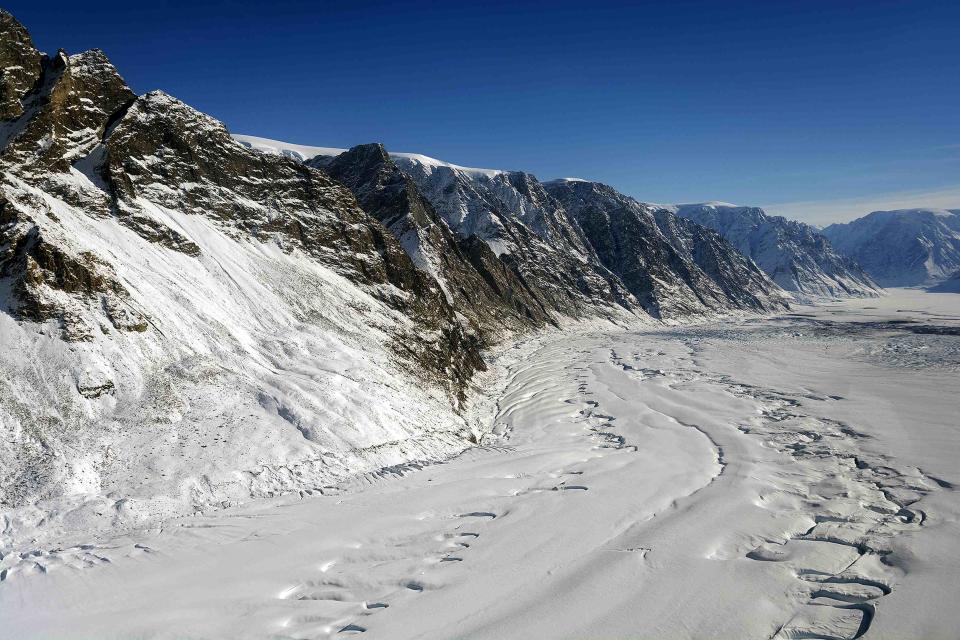 Meltwater channels from the previous summer and terminus of Violin Glacier in East Greenland