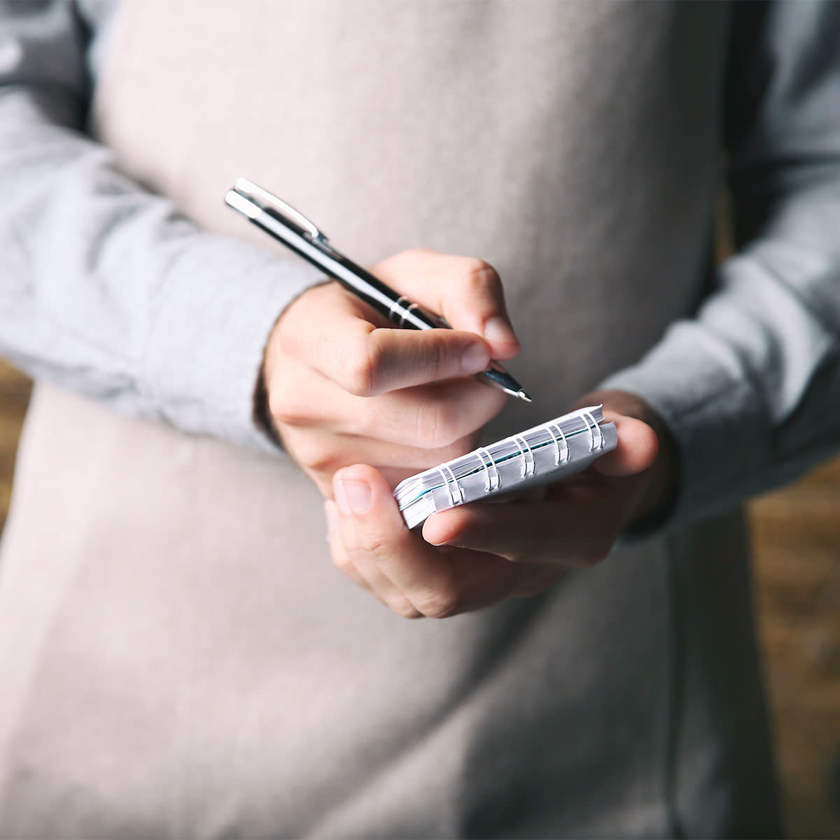 Waiter holding a notepad and pen at restaurant