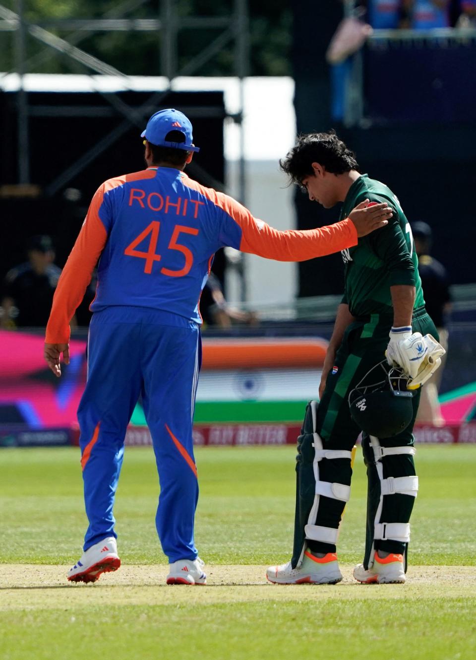 India's captain Rohit Sharma (2nd R) gives a pat on the shoulder to Pakistan's Naseem Shah (R) after India defeated Pakistan during the ICC men's Twenty20 World Cup 2024 cricket match at Nassau County International Cricket Stadium in East Meadow, New York on June 9, 2024.