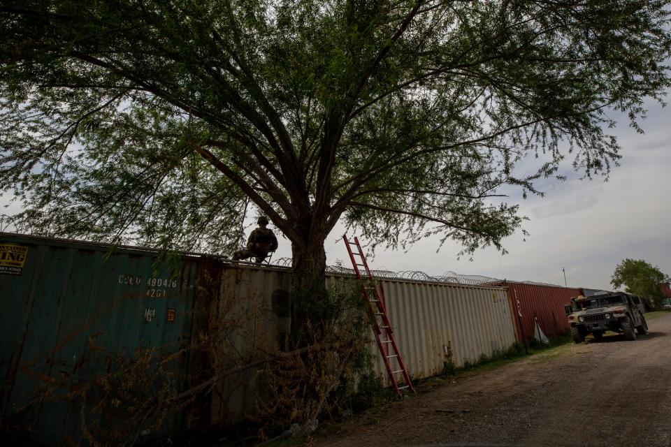 A Texas National Guard soldier keeps guard atop of shipping container in Shelby Park where the Texas Guard has set up infrastructure to prevent asylum seekers from entering U.S. territory from Piedras Negras, Mexico.