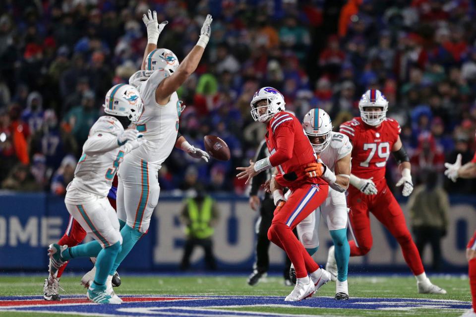 Dolphins linebacker Jaelan Phillips (15) forces a fumble by Bills quarterback Josh Allen in the game last December at Highmark Stadium.