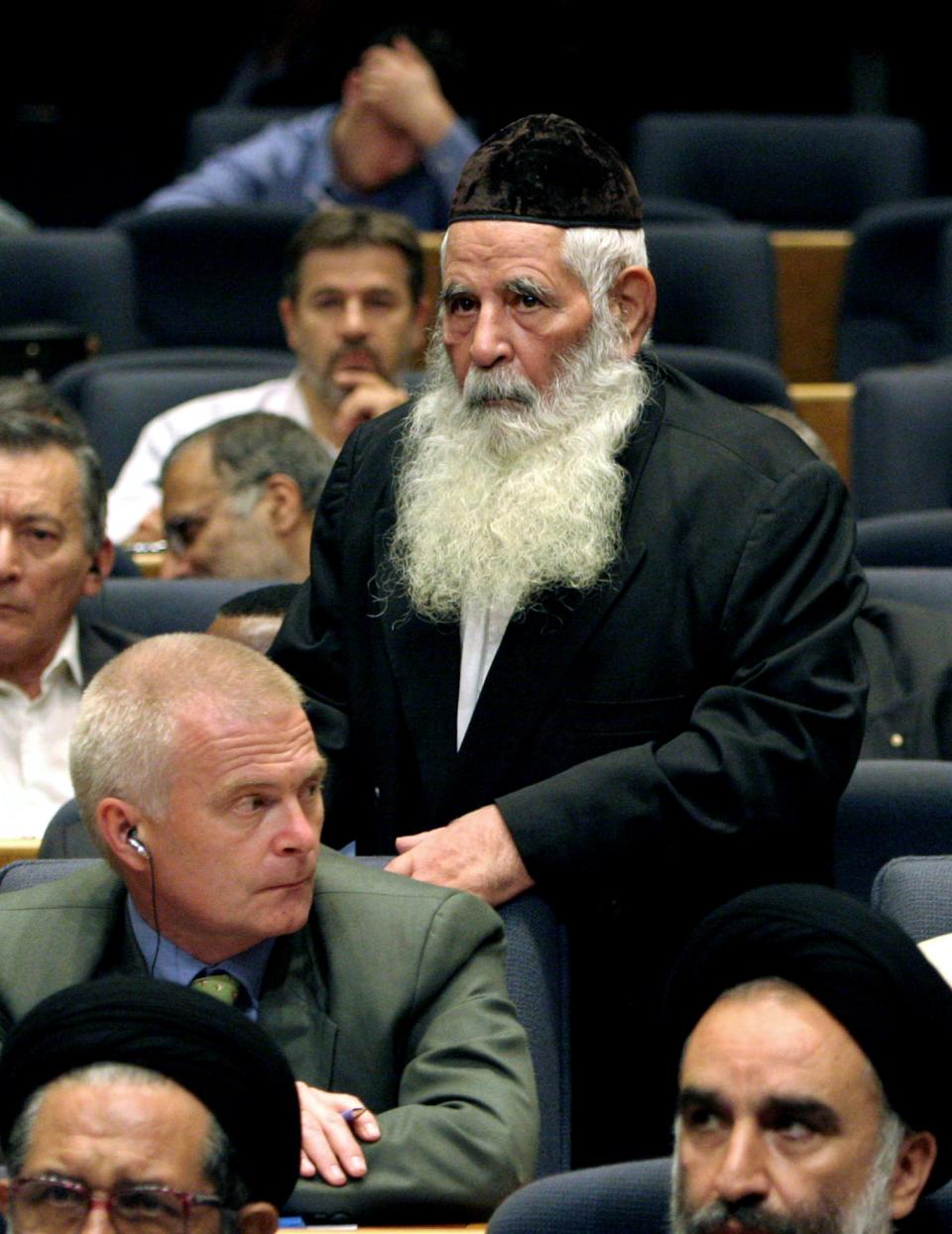 FILE - In this Tuesday, Aug. 1, 2006 file photo, Iran's Jewish community chief rabbi, Yousef Hamedani Cohen, center, arrives at a conference of Iranian parties to show support for Palestinians and Lebanon, in Tehran, Iran. Cohen, Iran's former chief rabbi and one of the cornerstones of its tiny Jewish community, has died. He was 98. (AP Photo/Vahid Salemi, File)