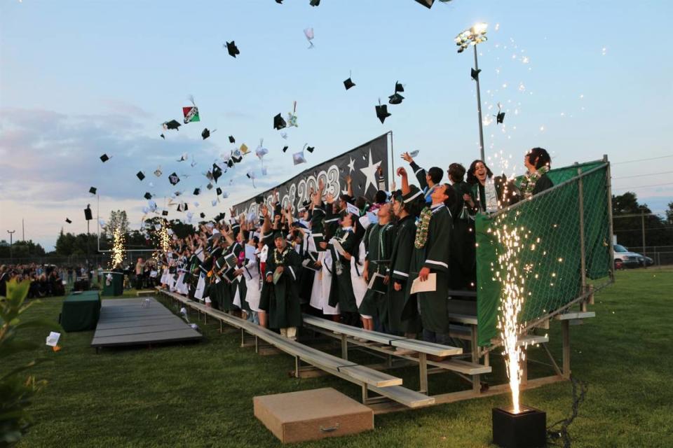 Templeton High School grads throw their caps in the air and cheer at the end of their commencement ceremony at Volunteer Stadium on June 8.
