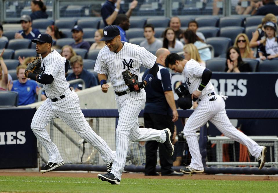 FILE - In this Aug. 3, 2012, file photo, New York Yankees shortstop Derek Jeter, center, runs onto the field with Robinson Cano, left, and Nick Swisher at the start of their baseball game against the Seattle Mariners at Yankee Stadium in New York. Secondary ticket websites are drawing increased attention from sports teams concerned about the effect of the low-price seats on their ability to sell their remaining inventory. (AP Photo/Kathy Kmonicek, File)
