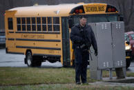 <p>A heavily armed law enforcement officer stands guard as students from Great Mills High School are evacuated to Leonardtown High School following a school shooting at Great Mills High School March 20, 2018 in Leonardtown, Maryland. (Photo: Win McNamee/Getty Images) </p>