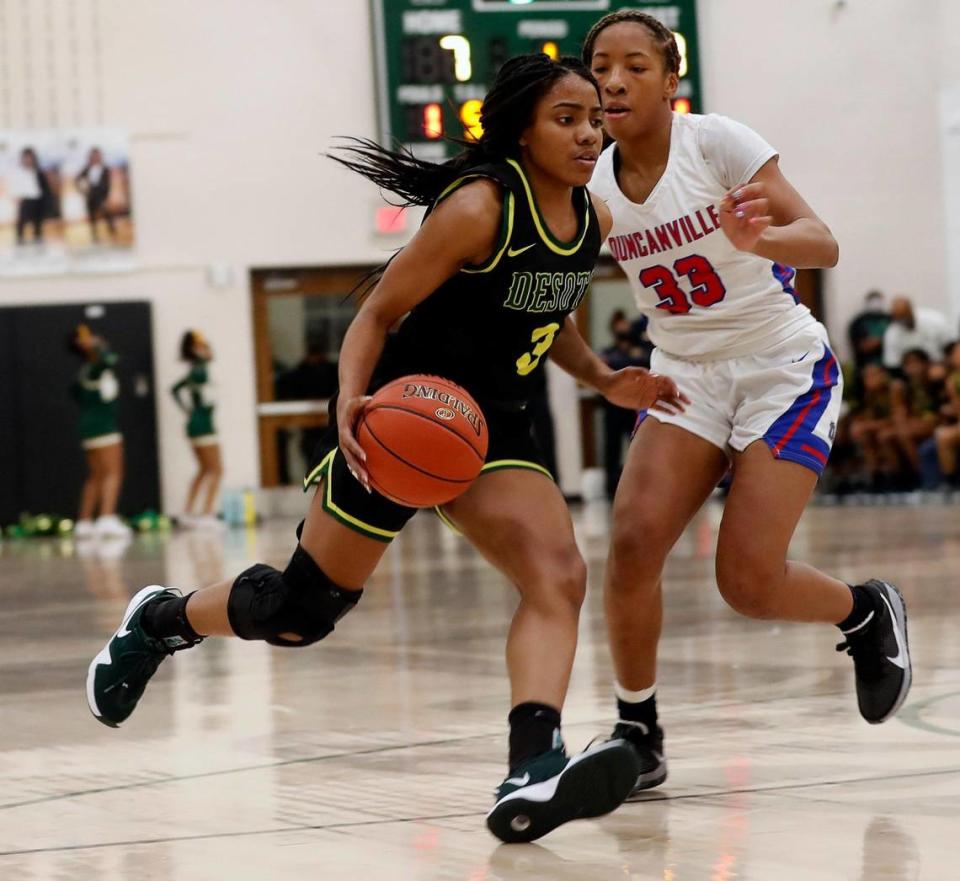 DeSoto guard Kayla Glover (3) crosses court in front of Duncanville guard Nyah Wilson (33) during the first half of the 6A Region II Regional Final basketball game at Waxahachie High School in Waxahachie, Texas, Tuesday, March 02, 2021. DeSoto led 24-19 at the half. (Special to the Star-Telegram Bob Booth)