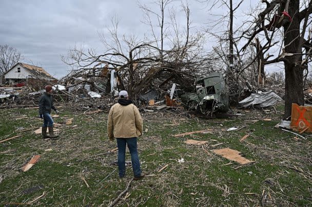 PHOTO: People look at a destroyed decommissioned helicopter that that was displayed at the Veterans of Foreign Wars (VFW) post 2459 the day after a tornado hit Sullivan, Indiana, U.S. April 1, 2023. REUTERS/Jon Cherry (Jon Cherry/Reuters)