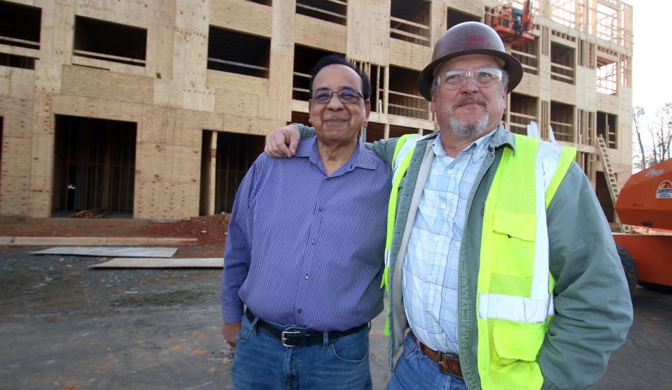Ashwin Shah and Robin Sandidge pose together outside thier new project on North New Hope Road Thursday morning, Dec. 16, 2021.