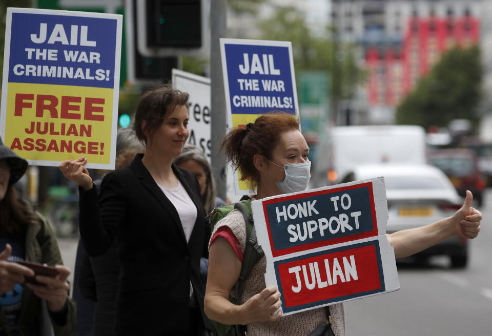 Supporters of WikiLeaks founder Julian Assange protest in front of Westminster Magistrates' Court in London, Monday, June 29, 2020, where he is expected to appear in custody for the extradition case management hearing. Assange was arrested last year after being evicted from the Ecuadorian Embassy in London, where he had sought refuge to avoid being sent to Sweden over allegations of rape and sexual assault, and is at the center of an extradition tussle over whether he should be sent to the United States. (AP Photo/Frank Augstein)