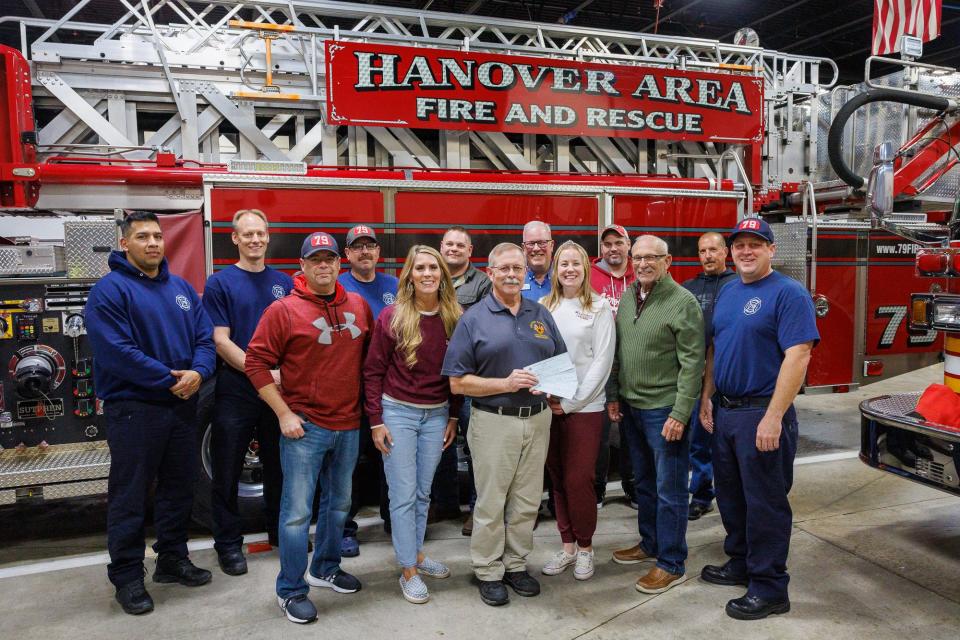 Firefighters of the IAFF 2045 union pose for a photo with representatives of the charities they raised money for while they present the checks to the charities, Tuesday, Nov. 21, 2023, at Hanover Area Fire & Rescue's Wirt Park firehouse in Hanover Borough. Front row, from left: firefighter Steve Kaiser, Christy Lucas of Roots for Boots, IAFF 2045 president Howard Billig, Michelle Fox of Olivia's House, Jack Corriere of the Rice Family Foundation, and firefighter Jay Lalley. Back row, from left: firefighter Adriel Garibay, firefighter Bryan Sponseller, firefighter Tim Tyler, Captain Joe Wysocki, Gene Hagenberger of New Hope Ministries, EMT/FF Bryan Bankert, and firefighter Steve Buhl.