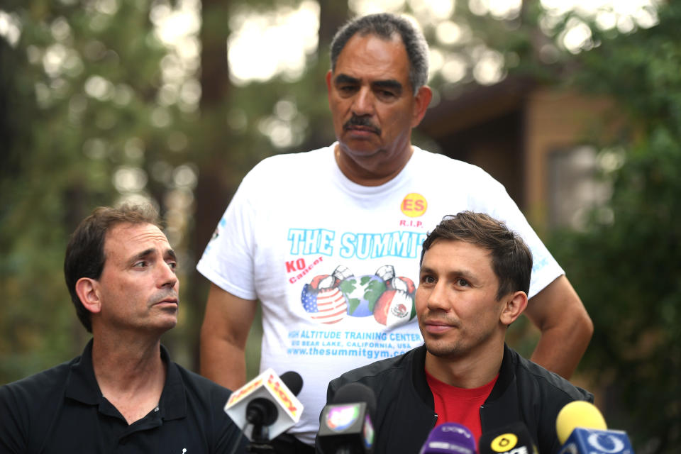 Gennady Golovkin (R) speaks to the media as he is joined by promoter Tom Loeffler (L) and trainer Abel Sanchez during a news conference on Aug. 9, 2018 in Big Bear Lake, California. (Getty Images)