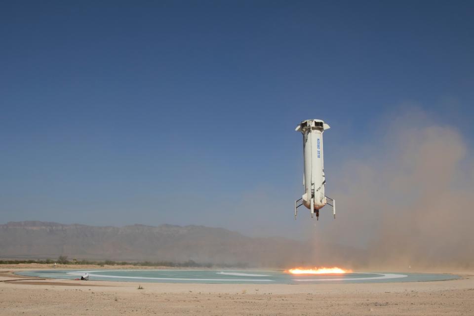 In this photo provided by Blue Origin, The booster of the New Shepard rocket prepares to land in a project called Mission 9 (M9) in western Texas on Wednesday, July 18, 2018. Jeff Bezos’ Blue Origin rocket company shot a capsule higher into space Wednesday than it’s ever done before. (Blue Origin via AP)