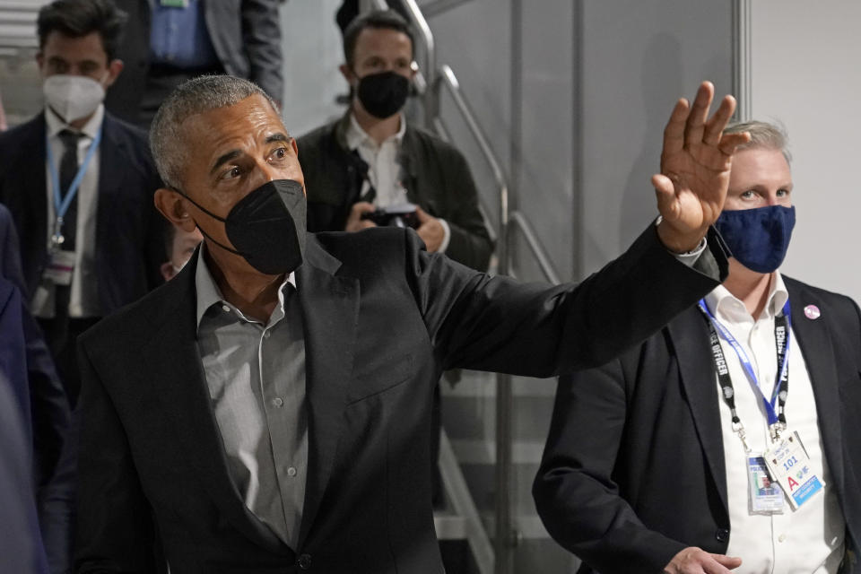 Former U.S. President Barack Obama waves as he arrives at an event during the COP26 U.N. Climate Summit in Glasgow, Scotland, Monday, Nov. 8, 2021. The U.N. climate summit in Glasgow is entering it's second week as leaders from around the world, are gathering in Scotland's biggest city, to lay out their vision for addressing the common challenge of global warming. (AP Photo/Alberto Pezzali)