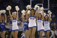 The Saint Louis dancers perform during the second half in a third-round game in the NCAA college basketball tournament against Louisville, Saturday, March 22, 2014, in Orlando, Fla. (AP Photo/Phelan M. Ebenhack)