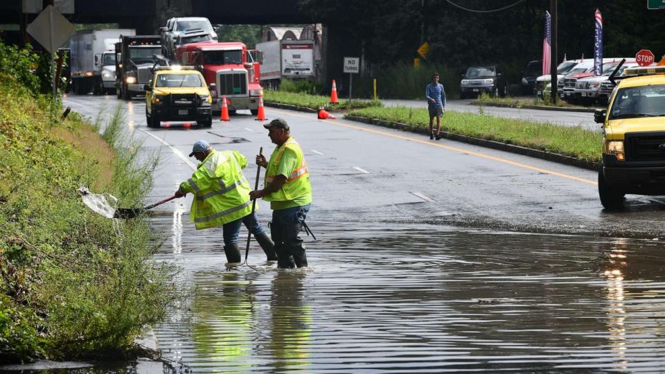 PHOTO: Two Massachusetts Department of Transportation employees work to clear storm drains at the Route 20 and Grafton Street overpass in Worcester, Mass., Aug. 8 The road was closed in both directions due to flooding from a passing storm. (Allan Jung/Telegram & Gazette/USA Today Network)