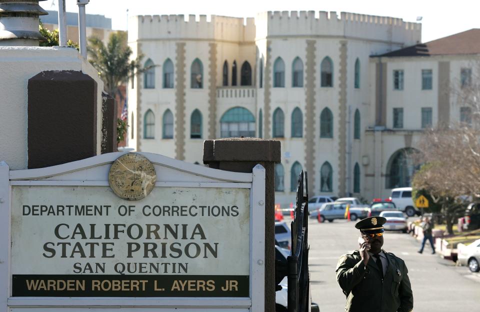 A guard stands at the entrance to San Quentin Prison.