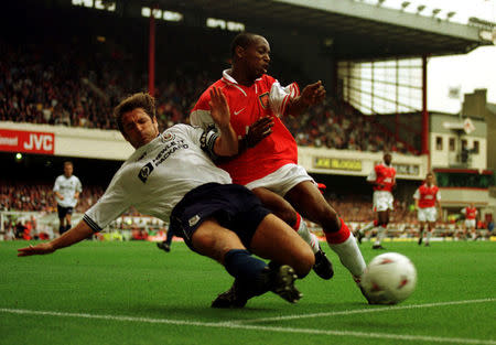 FILE PHOTO: Arsenal's striker Ian Wright (R) is tackled by Tottenham Hotspur's Gary Mabbutt at Highbury, London, Britain, August 30 1997. REUTERS/Kieran Doherty/File Photo